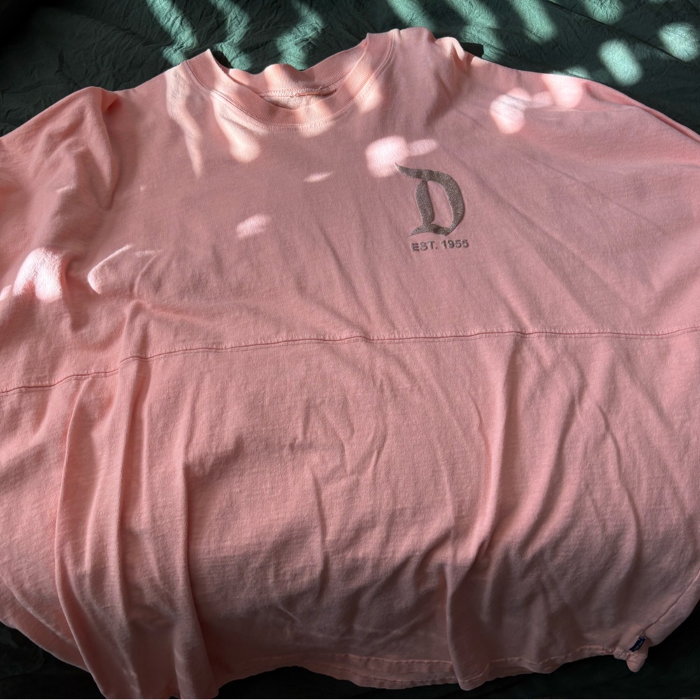 Disney Pink spirit jersey with gold writing